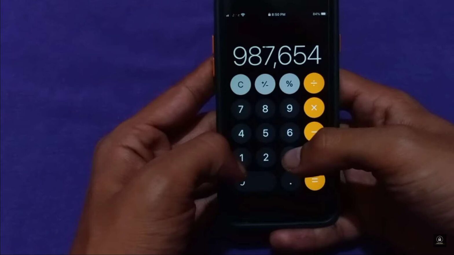 Close up of man using iPhone calculator