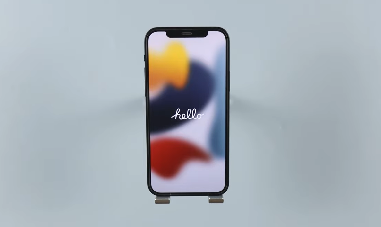 iPhone displaying colorful blurred background with a crisp 'hello' text